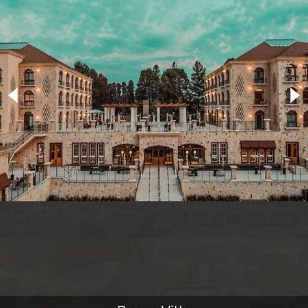 Buona Vitta Gramado Resort & Spa By Gramado Parks 외부 사진 The photo shows a spacious and elegant building design, likely a hotel or resort. The structure features multiple stories and large windows, with outdoor seating areas visible on a terrace or patio. The exterior has a combination of stone and modern 